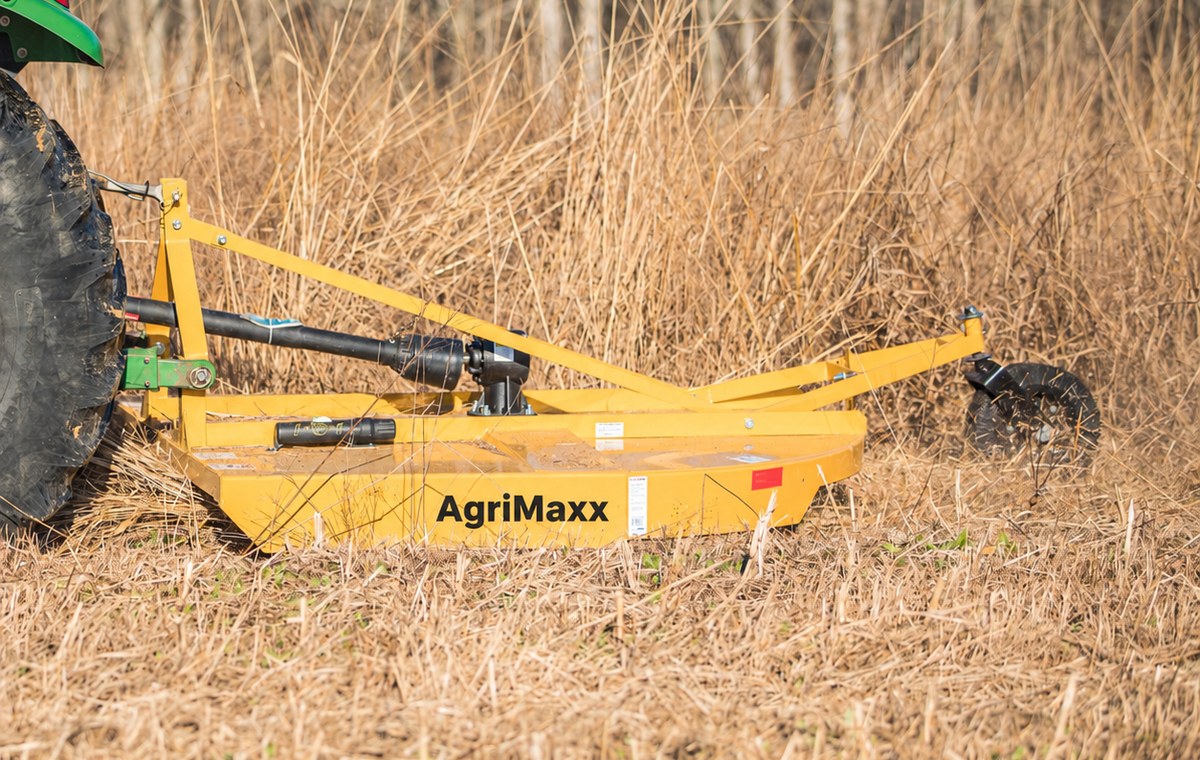 AgriMaxx RC72 rotary cutter mounted on a tractor, cutting through tall dormant grass and brush